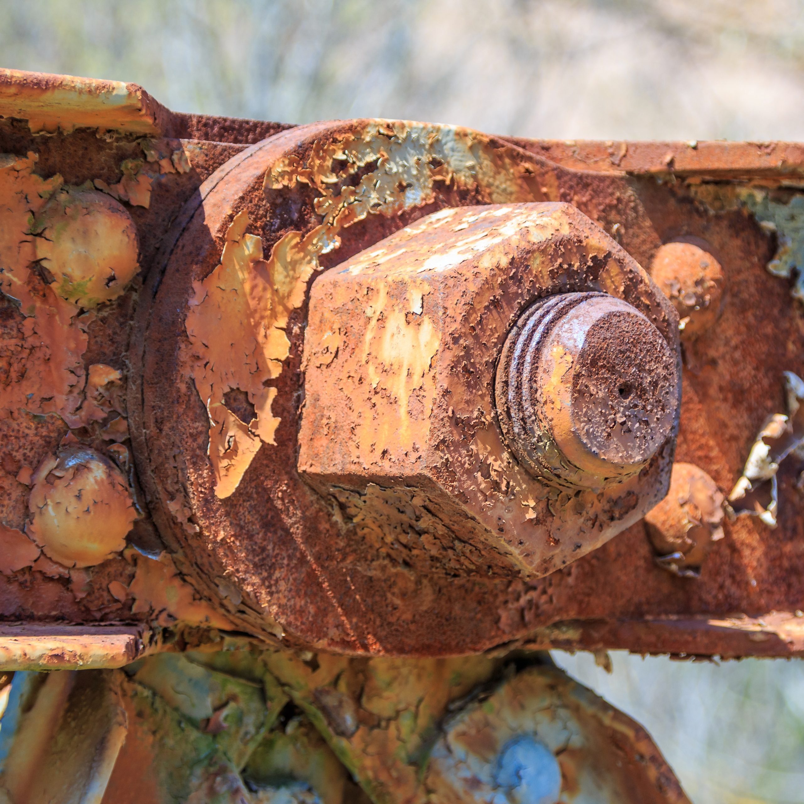 Side view of giant nut and bolt, very old and rusty